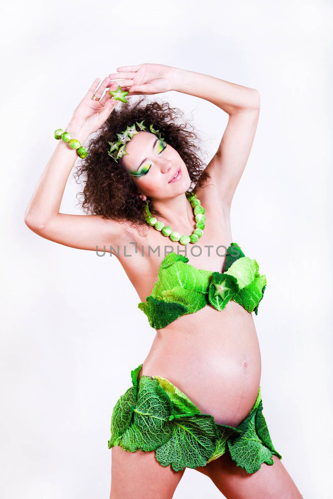 beautiful pregnant young woman dressed in cabbage