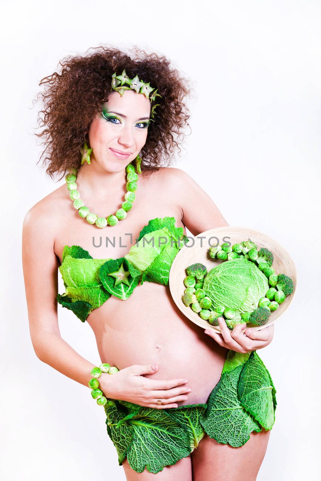 beautiful pregnant young woman dressed in cabbage