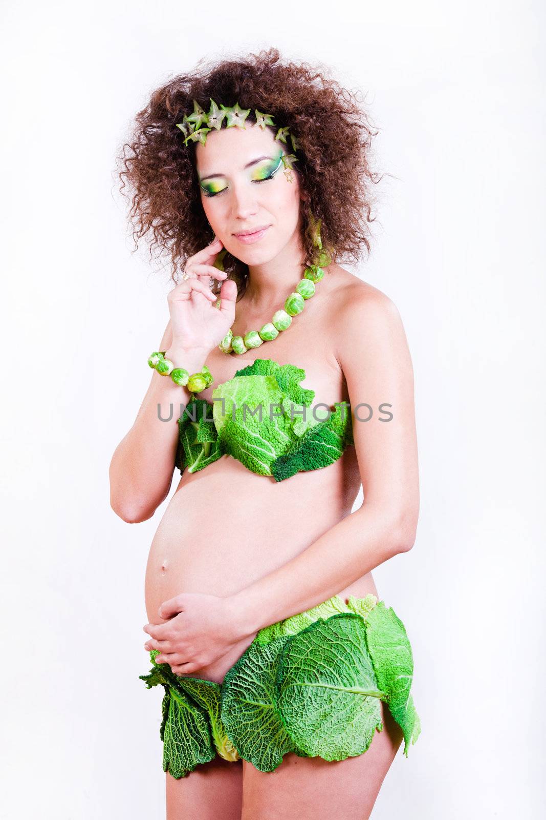 beautiful pregnant young woman dressed in cabbage