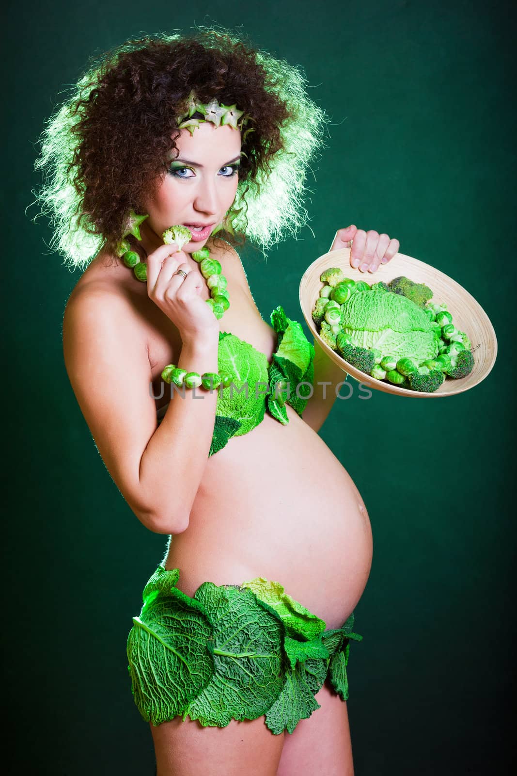 beautiful pregnant young woman dressed in cabbage