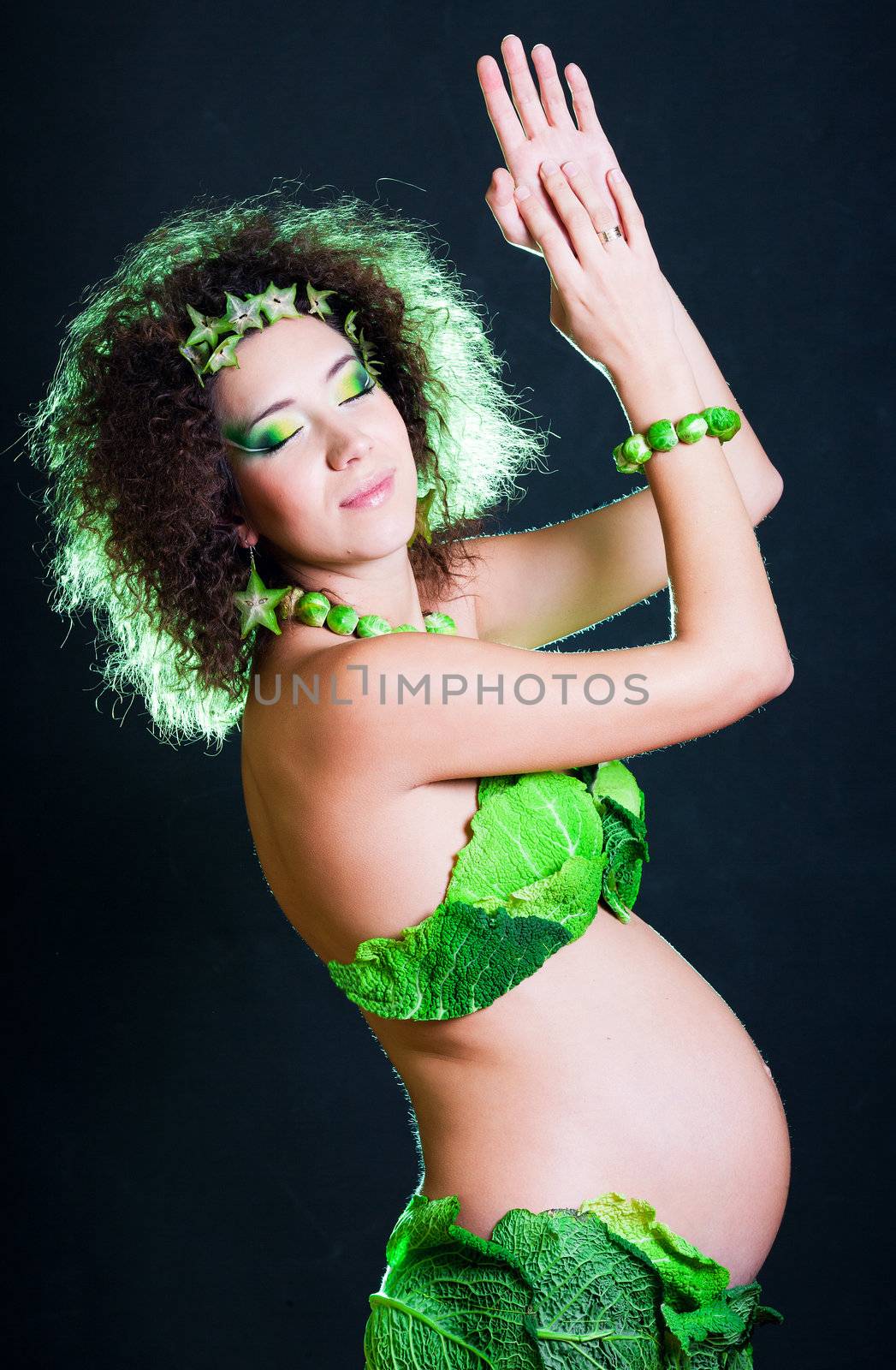 beautiful pregnant young woman dressed in cabbage