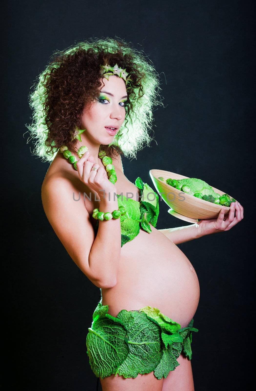 beautiful pregnant young woman dressed in cabbage