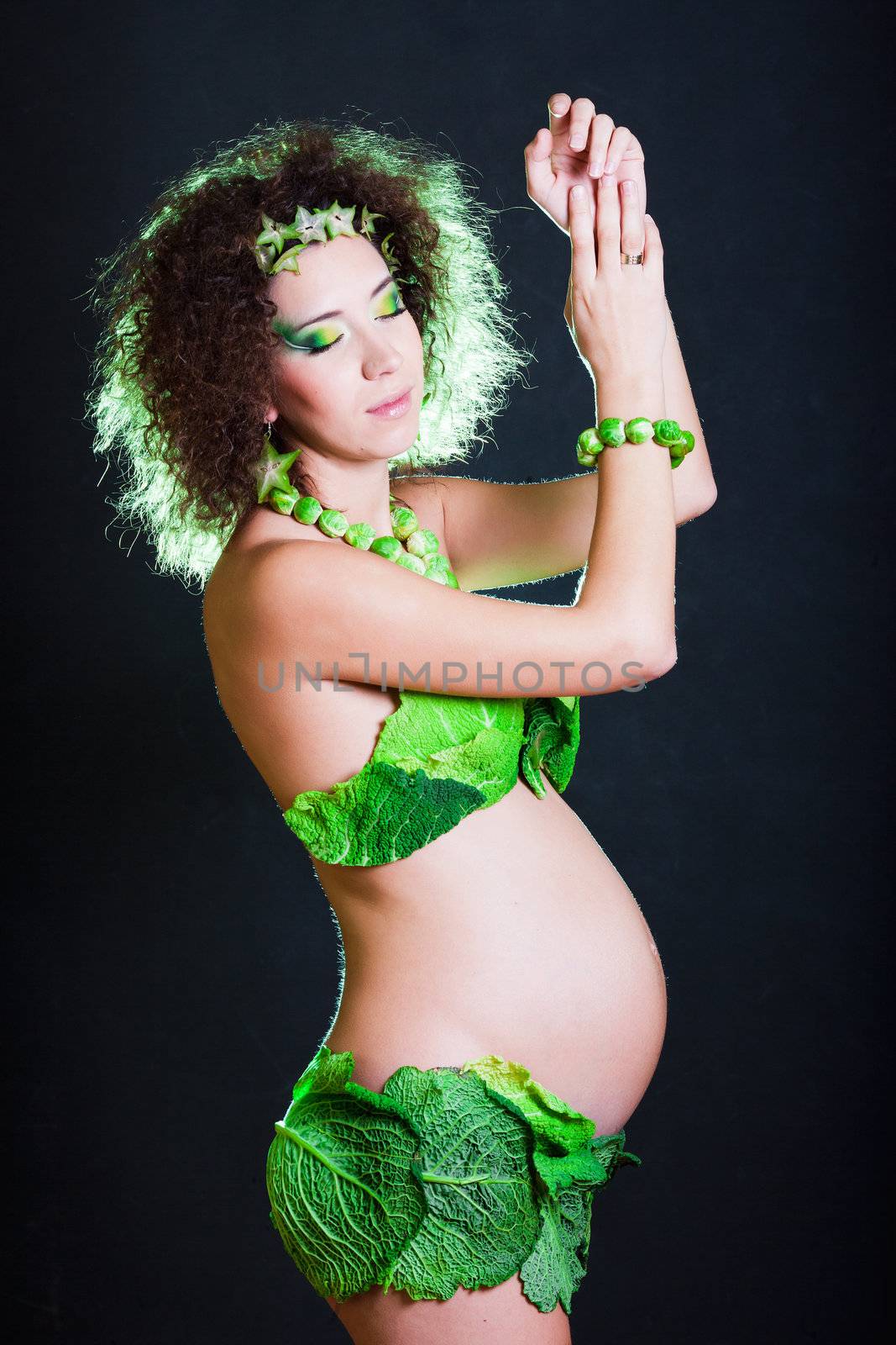 beautiful pregnant young woman dressed in cabbage