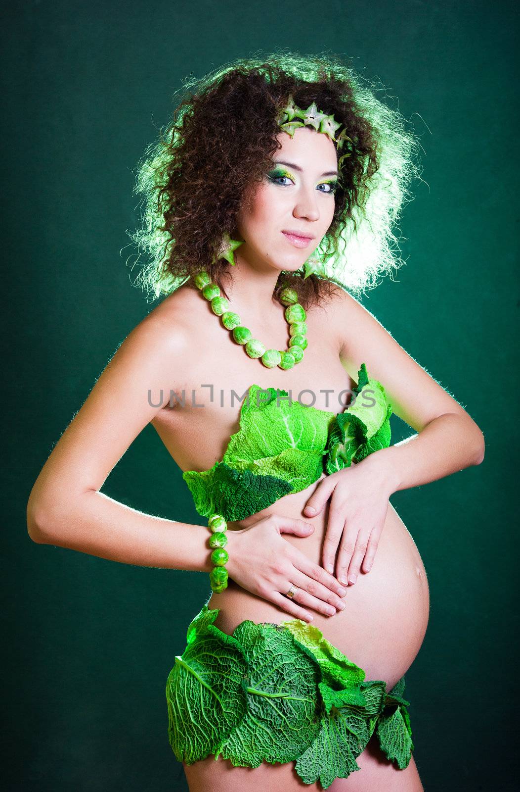 beautiful pregnant young woman dressed in cabbage