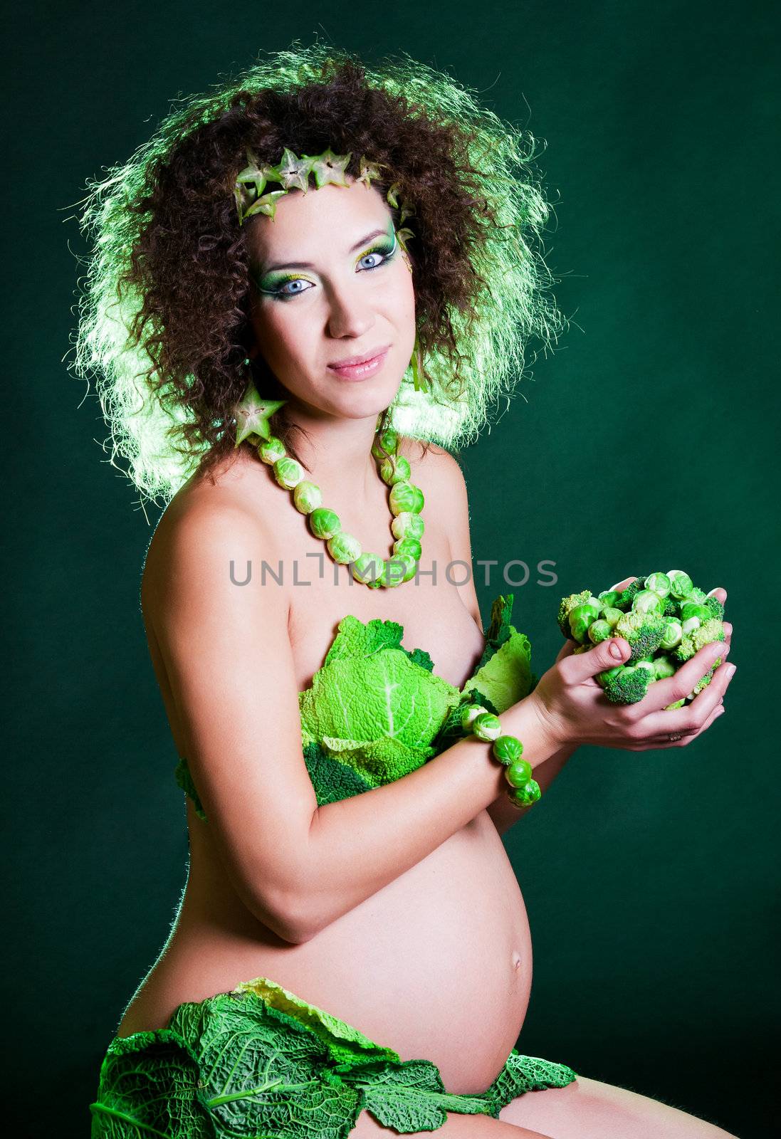 beautiful pregnant young woman dressed in cabbage