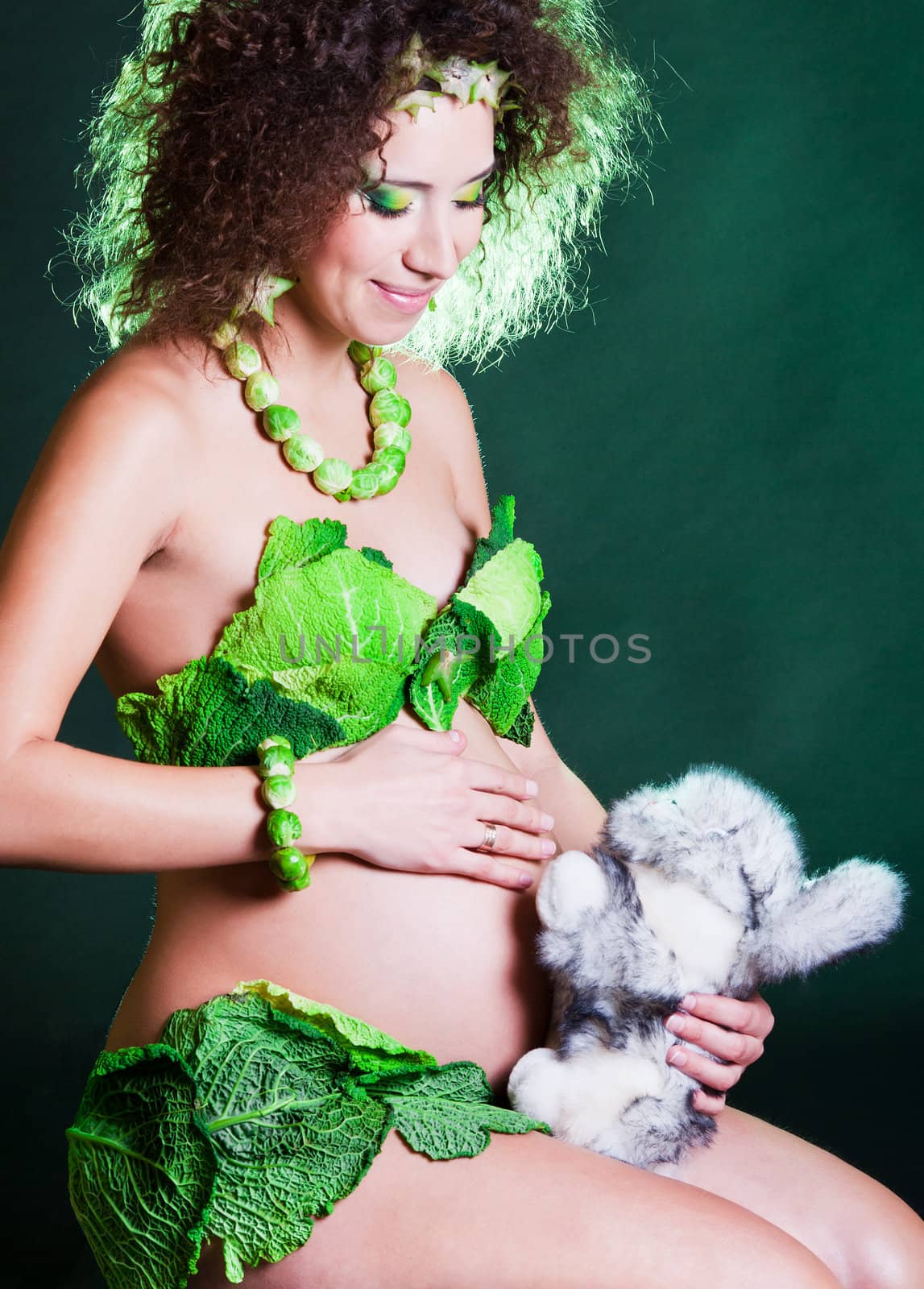 beautiful pregnant young woman dressed in cabbage