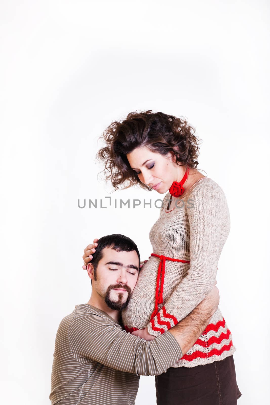 pregnant woman with her ​​husband and child isolated on white background