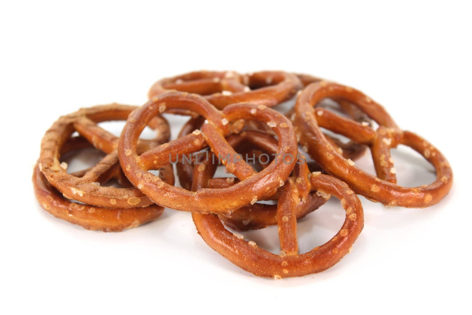 a handful of salt pretzels on a white background
