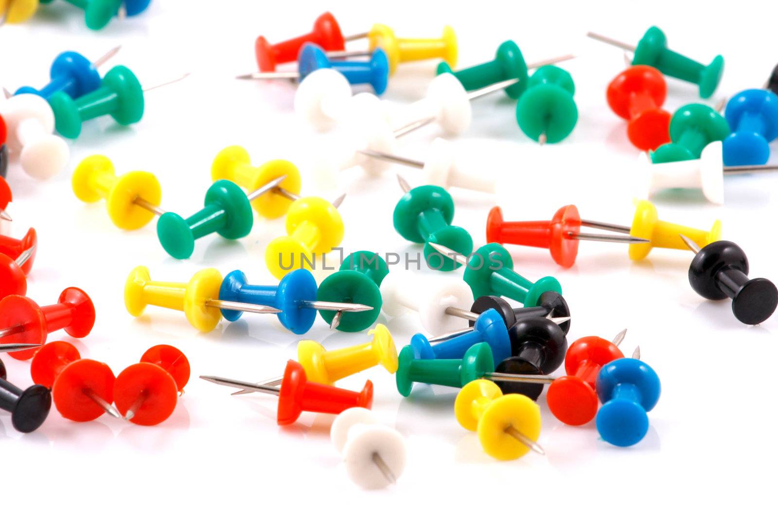 Collection of various pushpins on white background