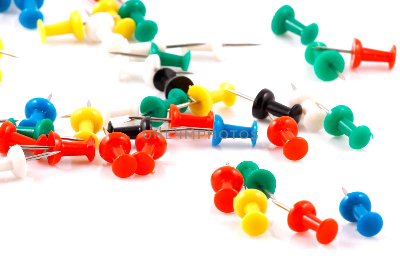 Collection of various pushpins on white background