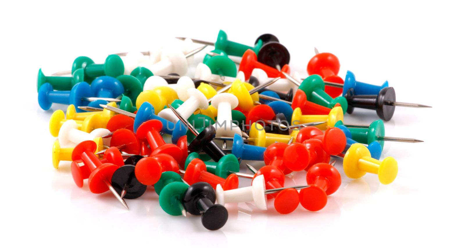 Collection of various pushpins on white background
