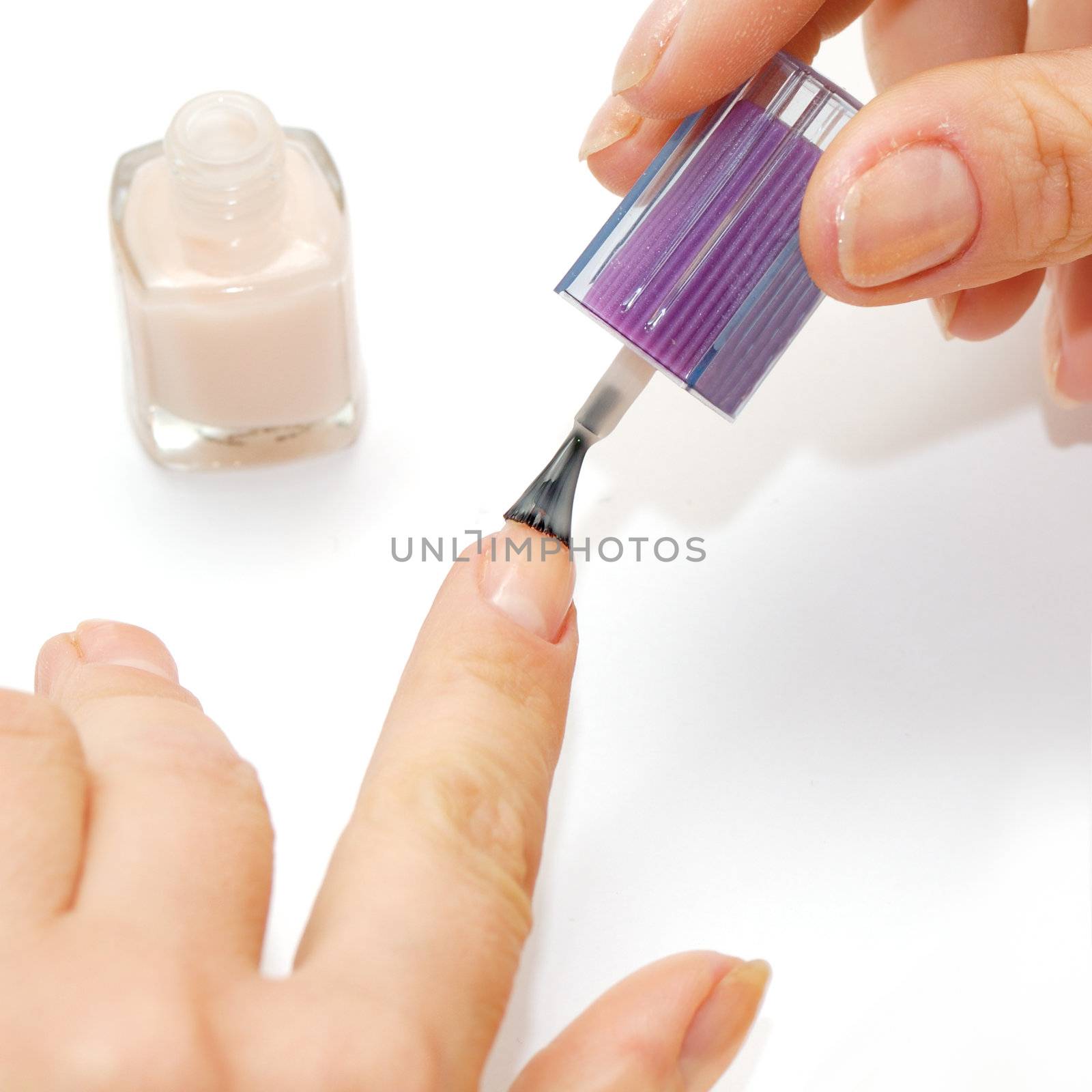 Female hands and nail polish isolated on a white background.