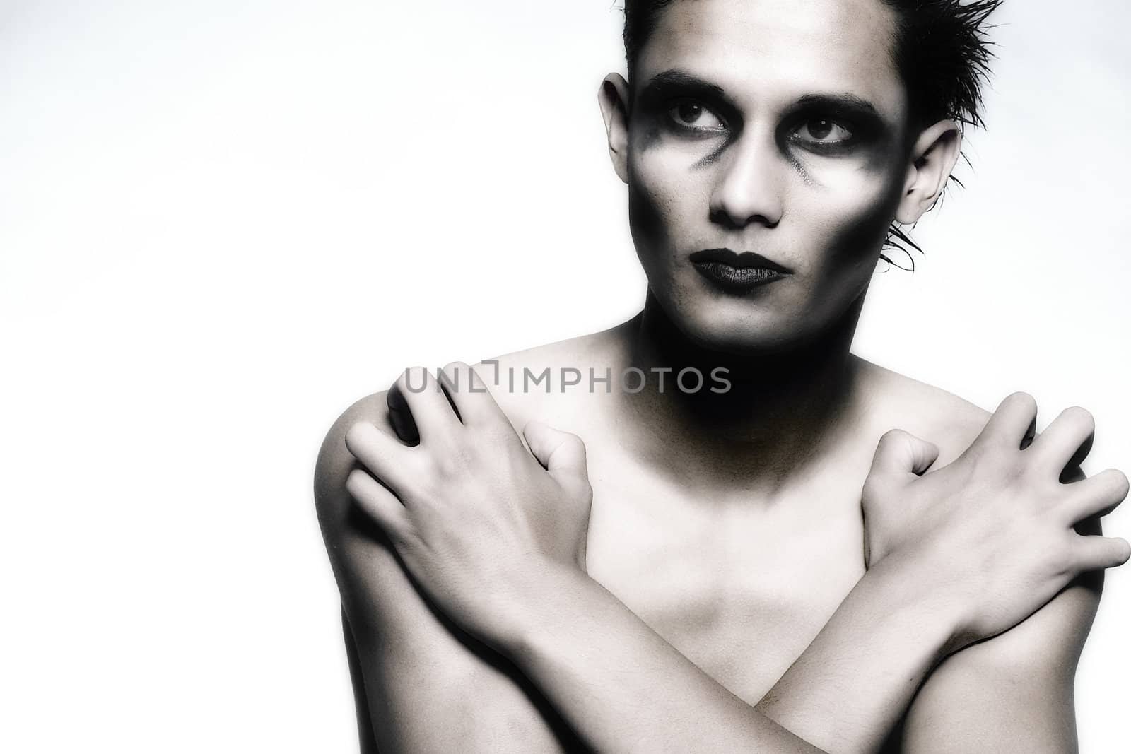 Studio portrait of mixed race young man looking protective