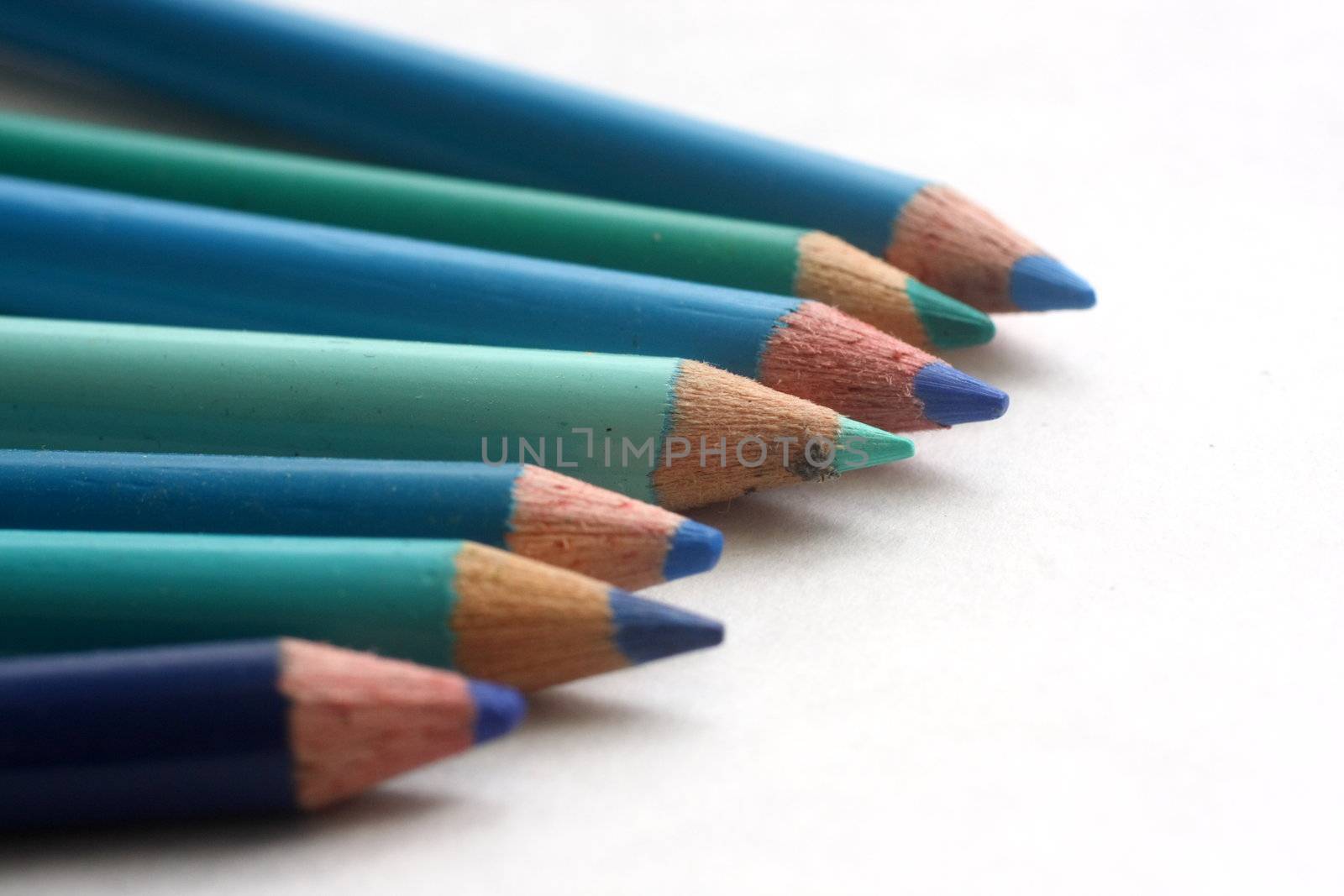 Coloring pencils of blue hues on white background