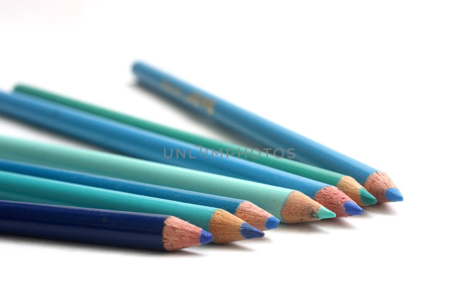 Coloring pencils of blue hues on white background