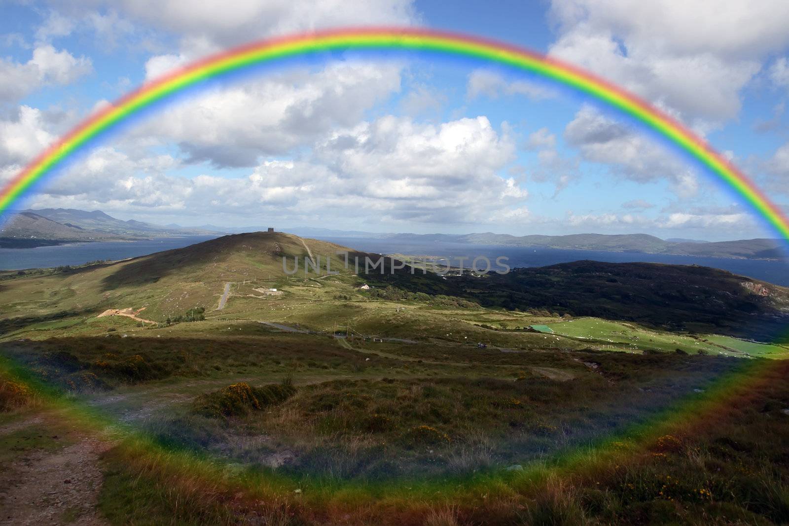 the view from a hillside on Bear island county Cork Ireland on a wet day with rainbow in background