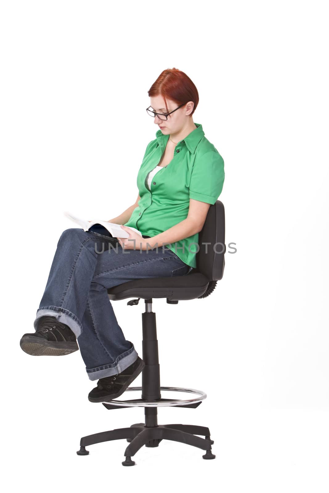 Girl with green blouse reading a book.