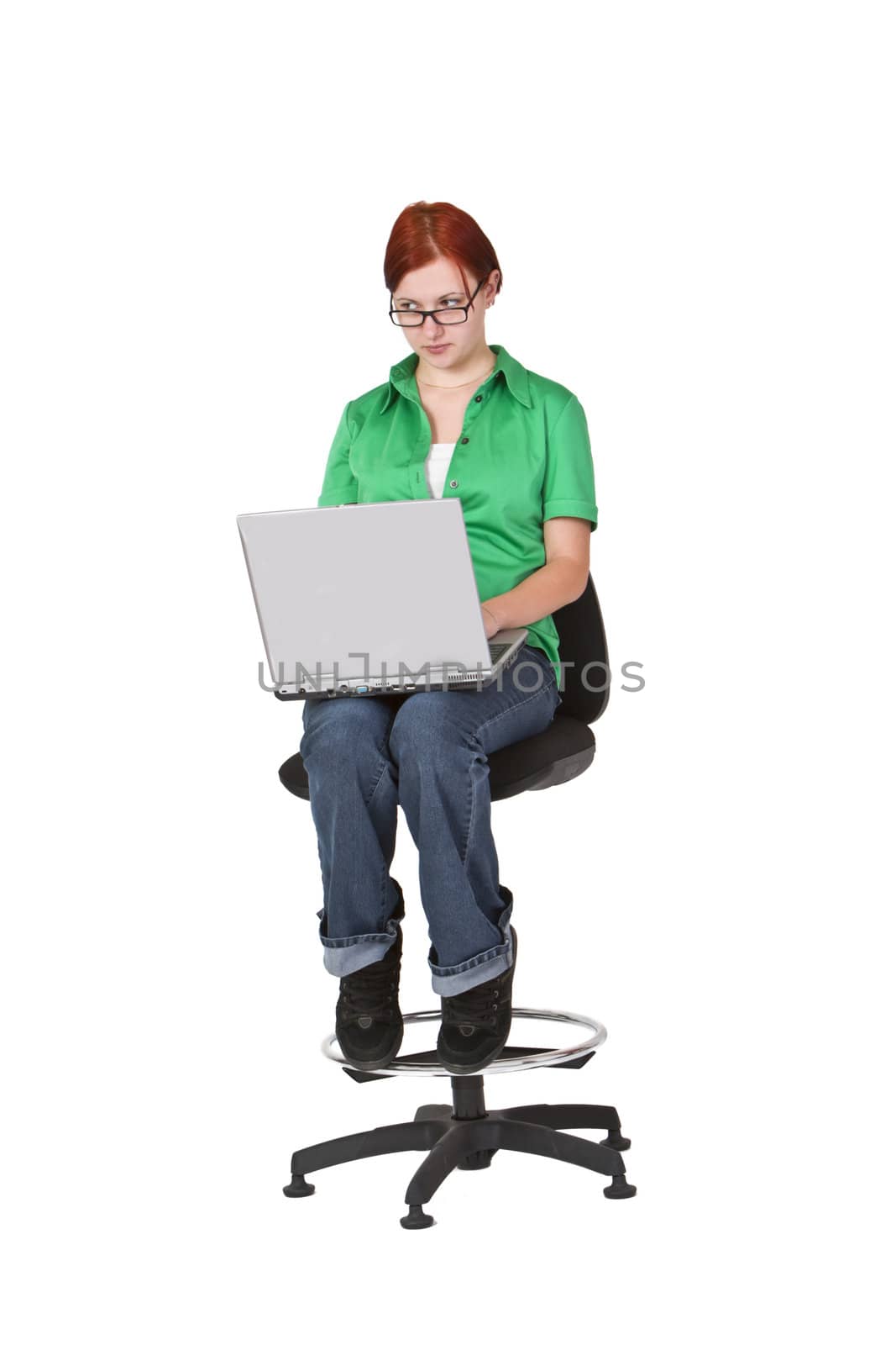 Girl with a laptop in her lap looking above the glasses.