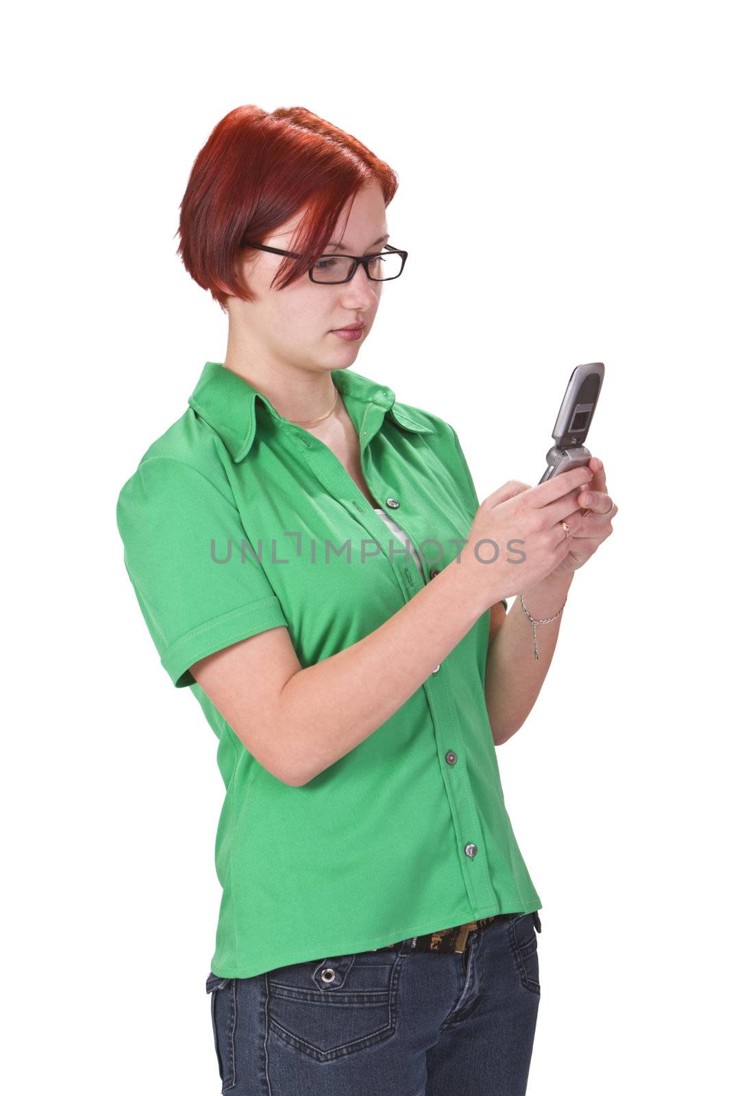 Redheaded girl using a mobile phone, against a white background.Shot with Canon 70-200mm f/2.8L IS USM