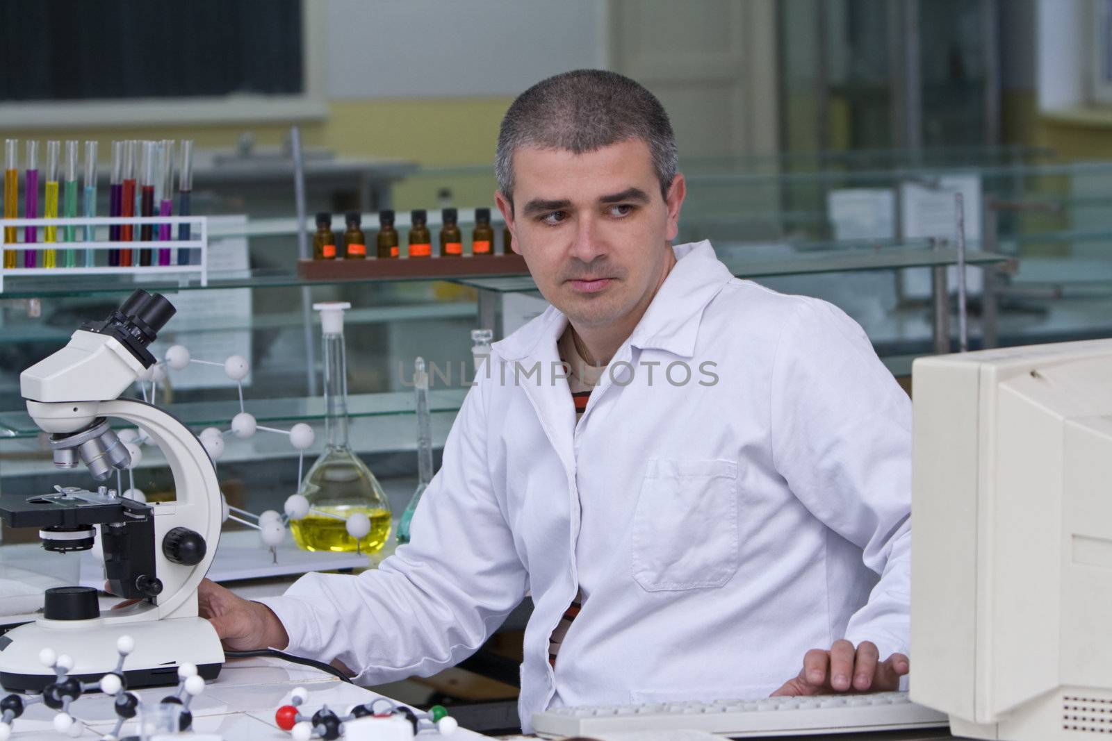 A researcher checking data on the computer computer at his workplace.SShot with Canon 70-200mm f/2.8L IS USM