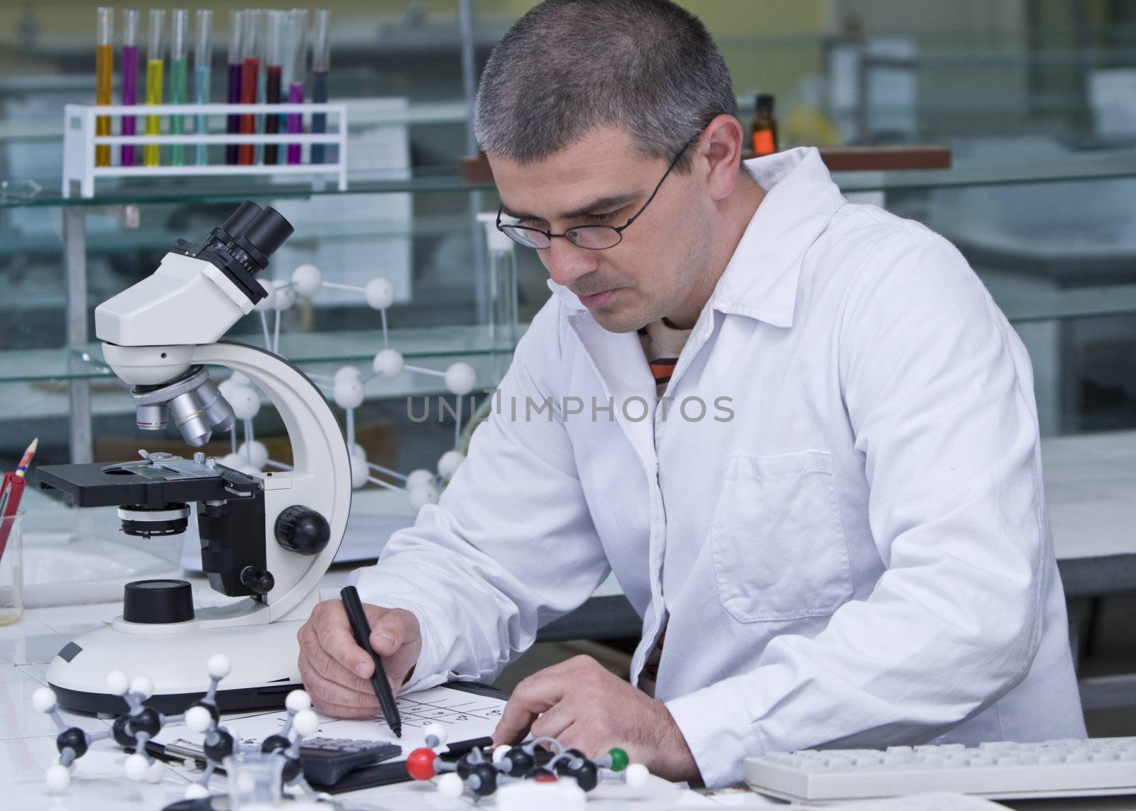 A researcher doing some calculation at his workplace.All the inscriptions are mine.