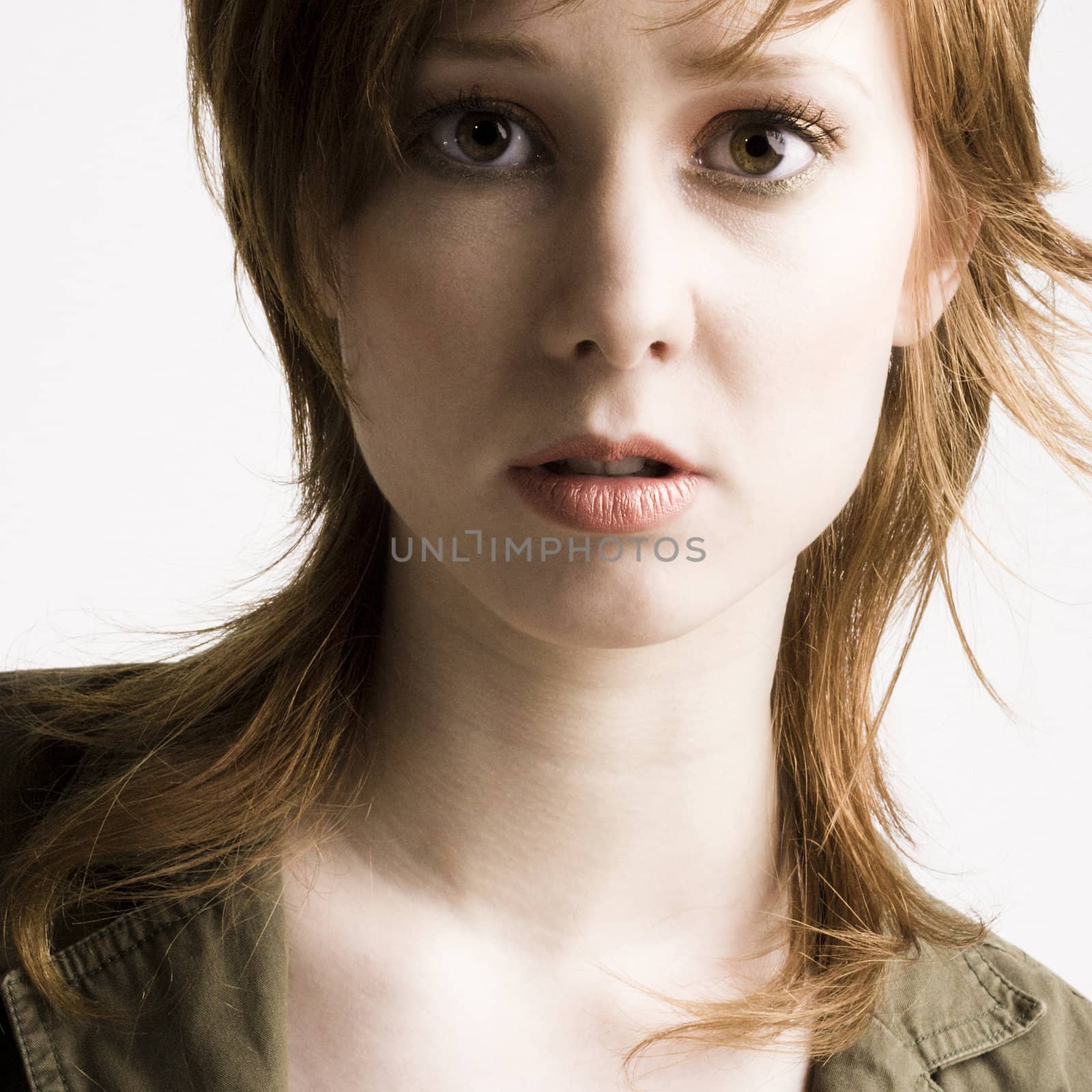 Portrait of a red haired girl looking curious