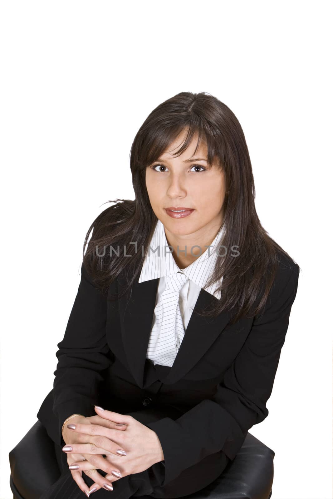 Portrait of a young businesswoman sitting and looking up to the camera.