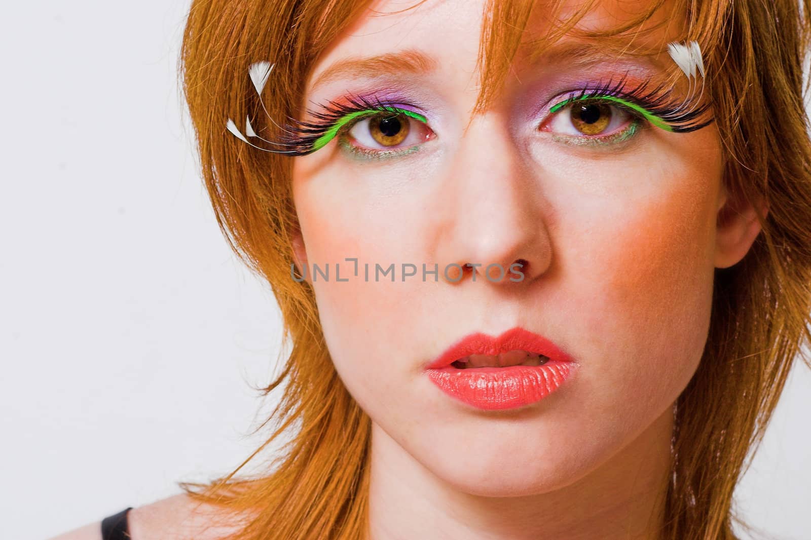 Portrait of a red haired girl with extreme make-up