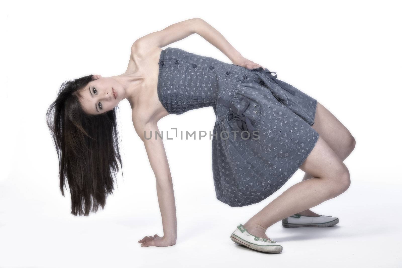 Studio portrait of a beautiful mixed race, vietnamese girl stretching