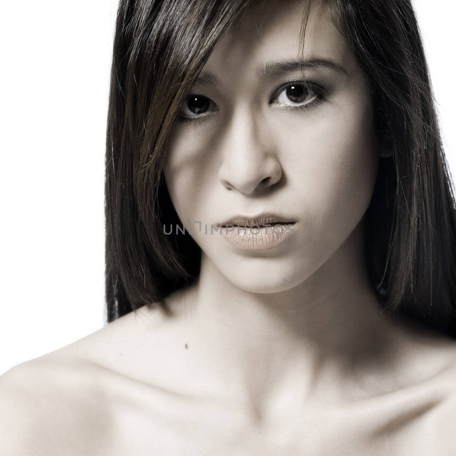 Studio portrait of a beautiful mixed race, vietnamese girl with an angry look