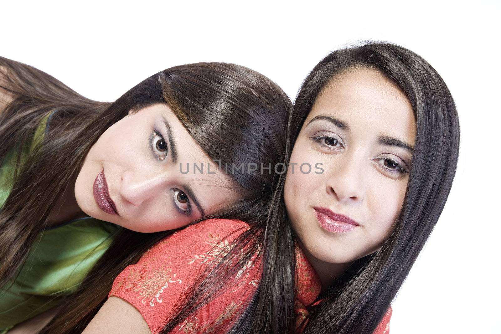 Studio portrait of two beautiful mixed race sisters