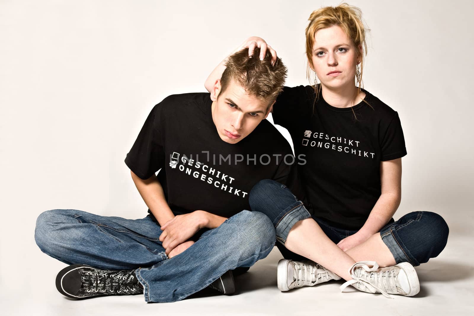 Couple of teenagers in the studio on a white background having fun
