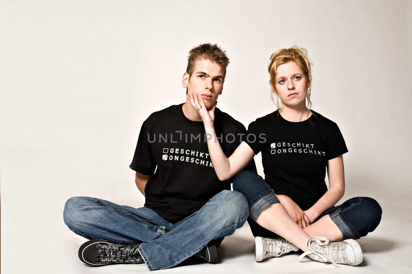 Couple of teenagers in the studio on a white background
