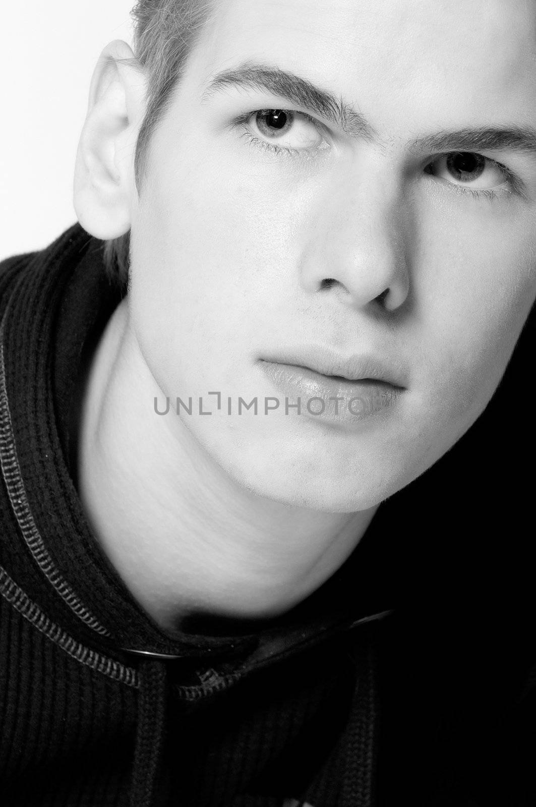 studio portrait of a young man looking up in thoughts
