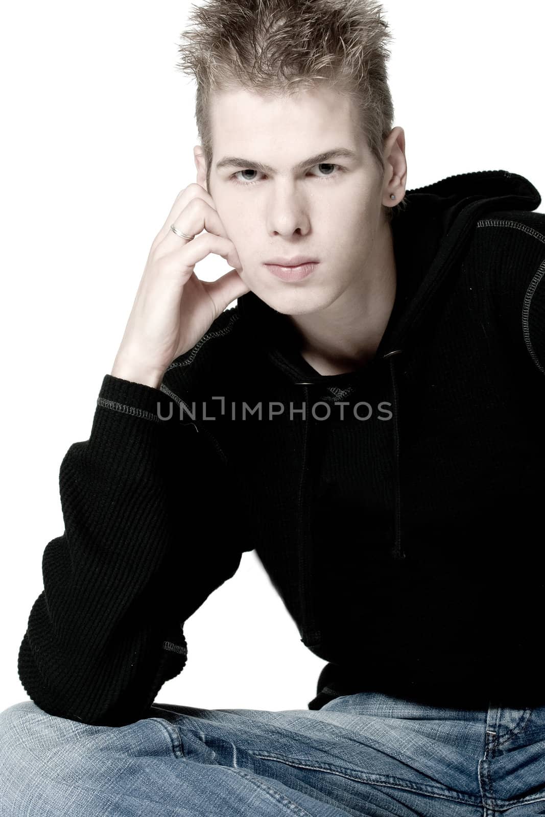 studio portrait of a young man pouting
