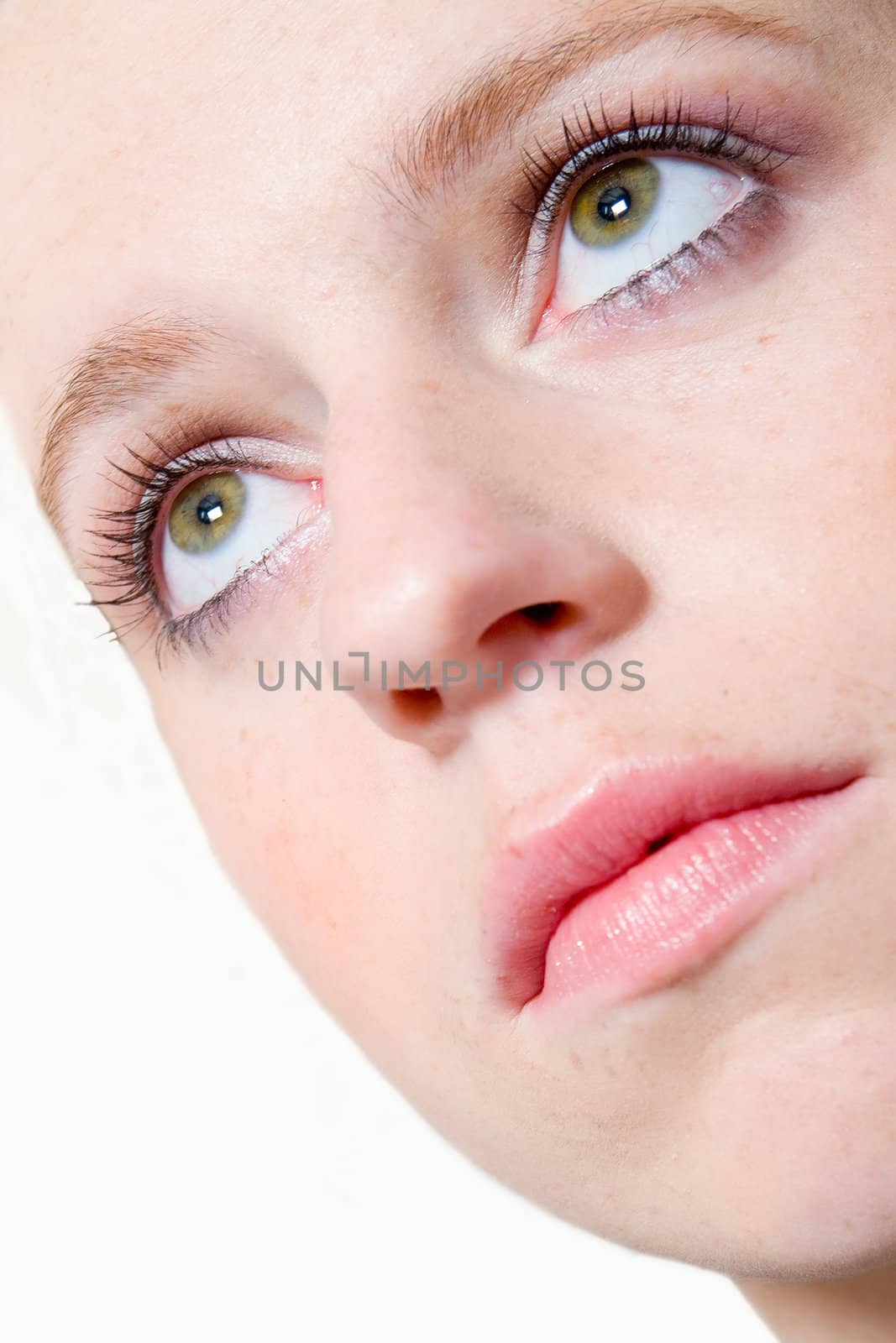 Studio portrait of young girl with reddish hair looking up
