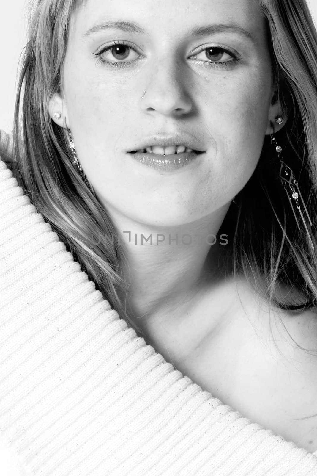 Studio portrait of young girl with reddish hair looking alife
