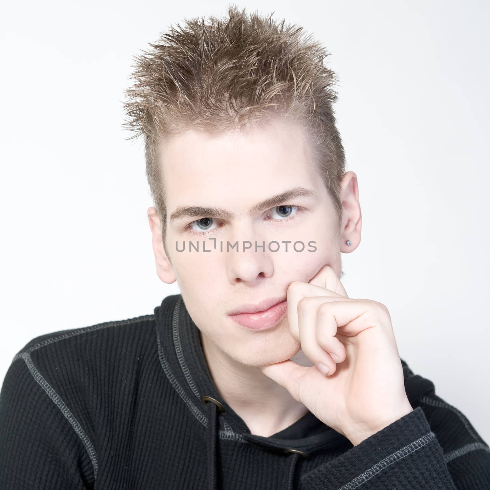 studio portrait of a thinking young man 
