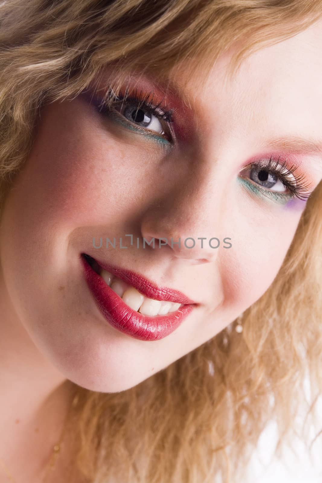 Studio portrait of a curly blond female