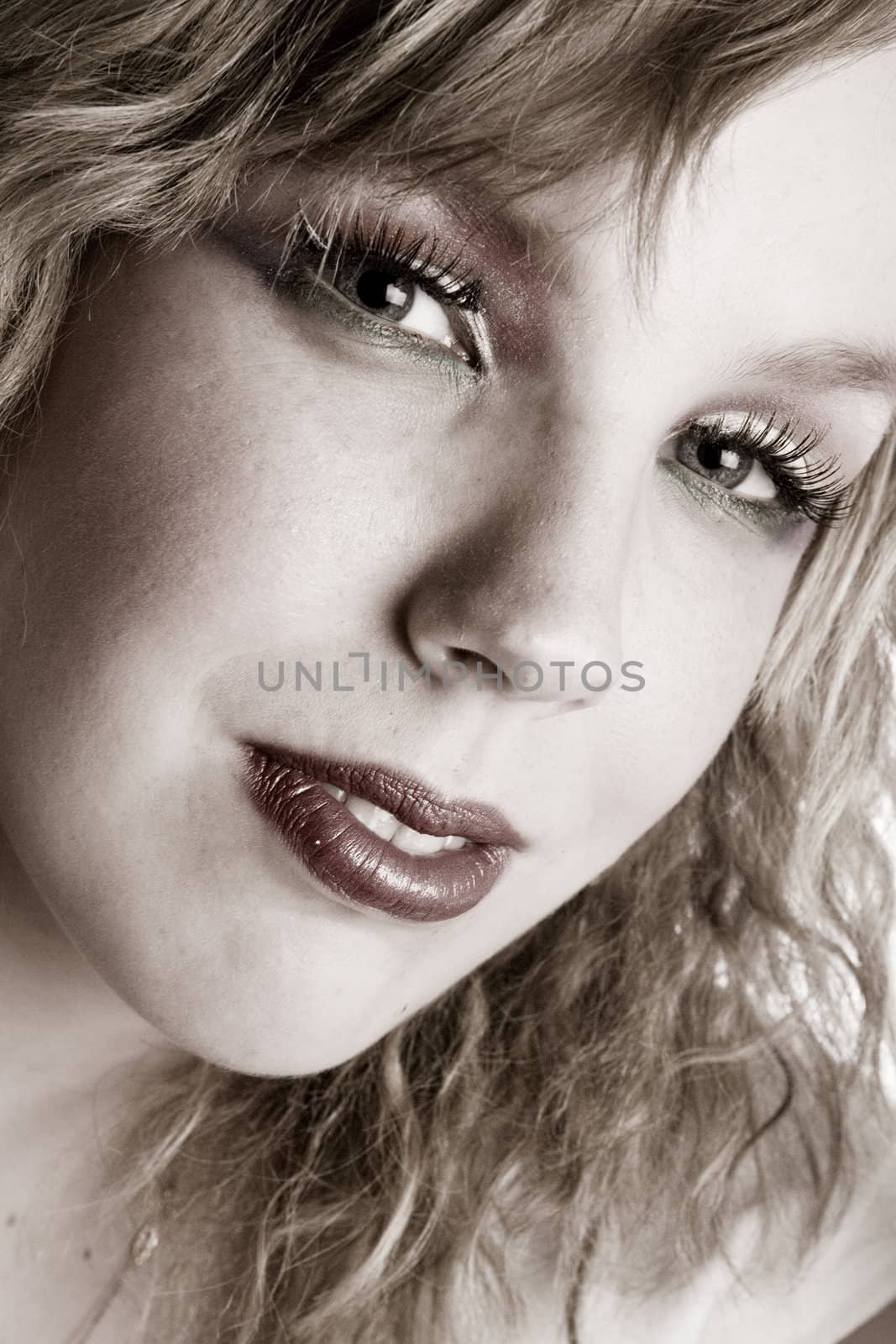 Studio portrait of a curly blond female