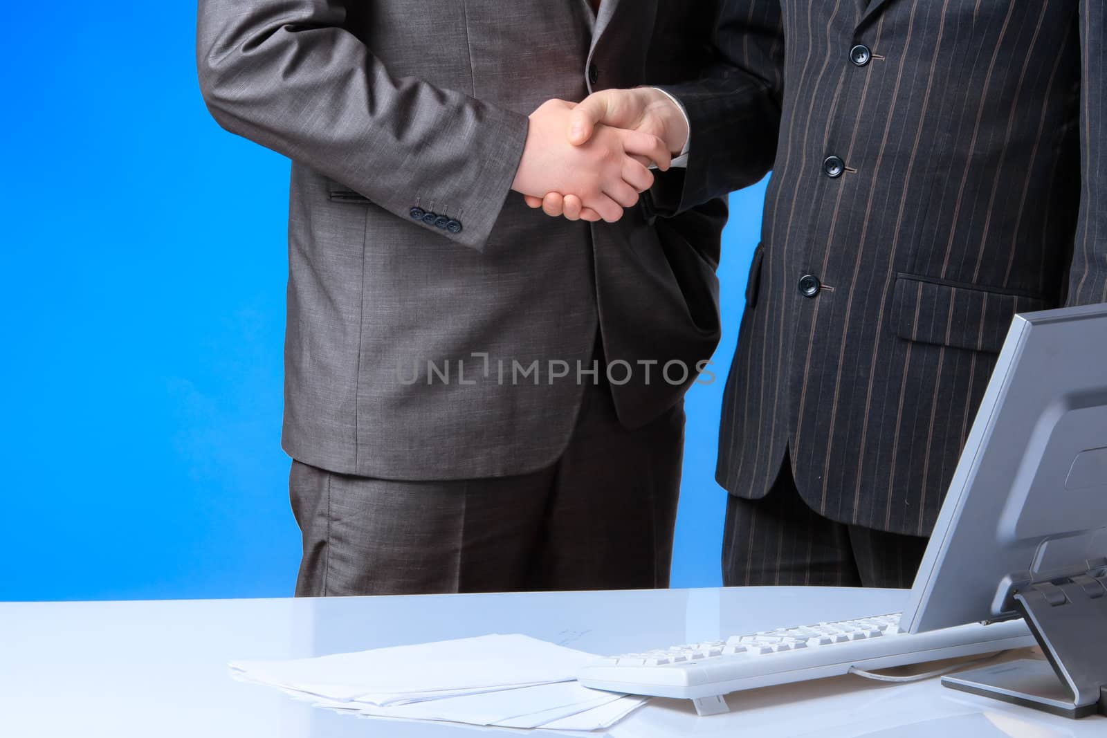 Two business men shake hands each other
