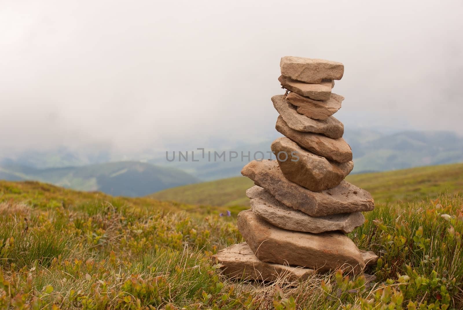 Stack of stones laying in the mountains by AndreyKr