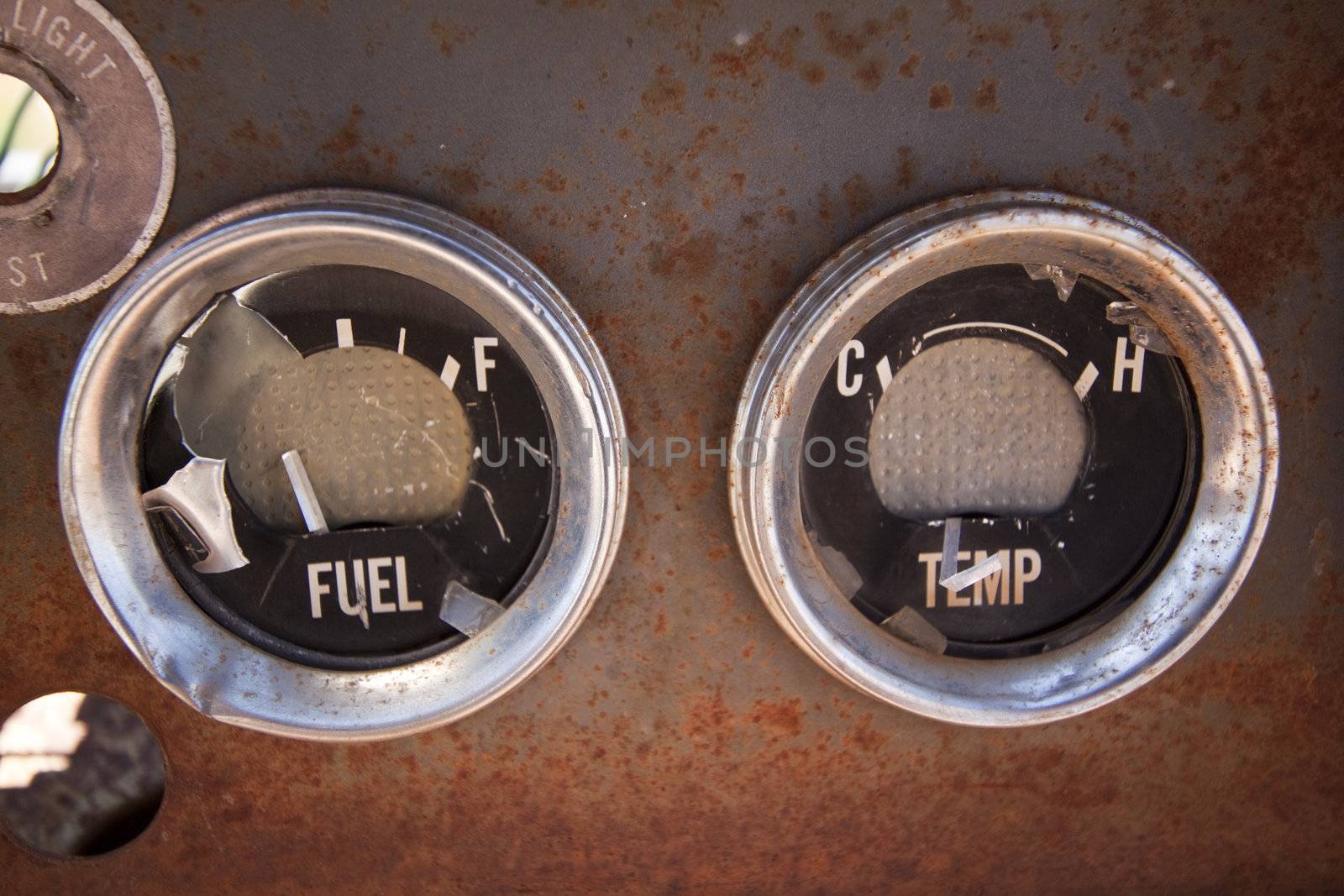 A pair of old rusty gauges in an abandoned car.