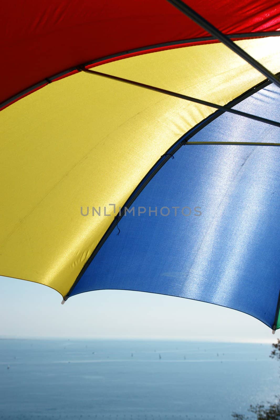 colorful parasol at the ocean on a sunny day