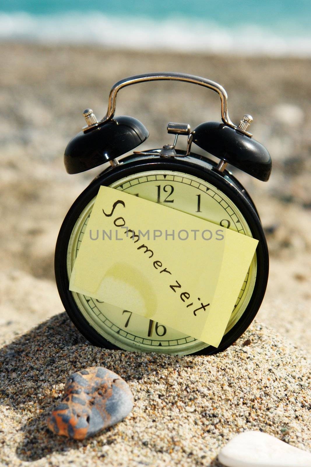 a closeup of an old clock on a beach