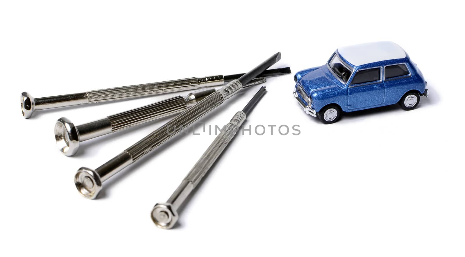 miniature car and a screwdrivers isolated on white