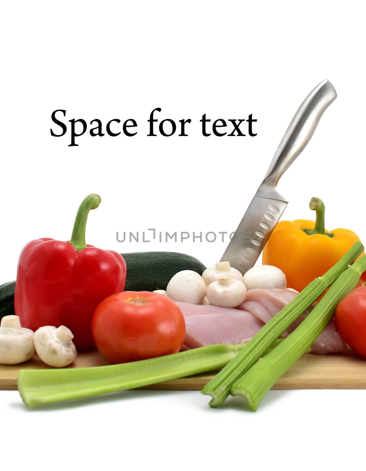 chicken, knife and vegetables on a cutting board, isolated on white, space for text