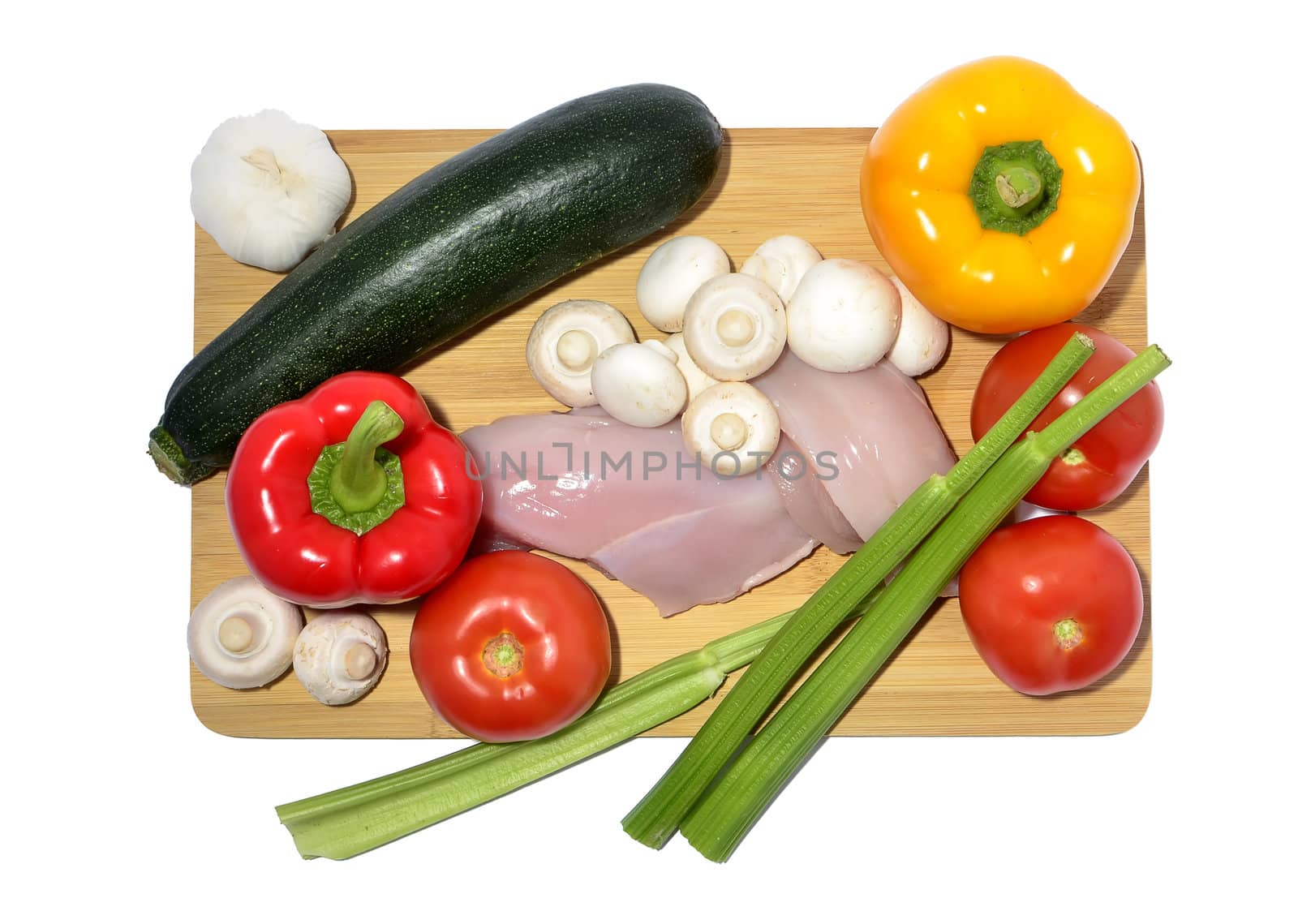 chicken, knife and vegetables on a cutting board, isolated on white