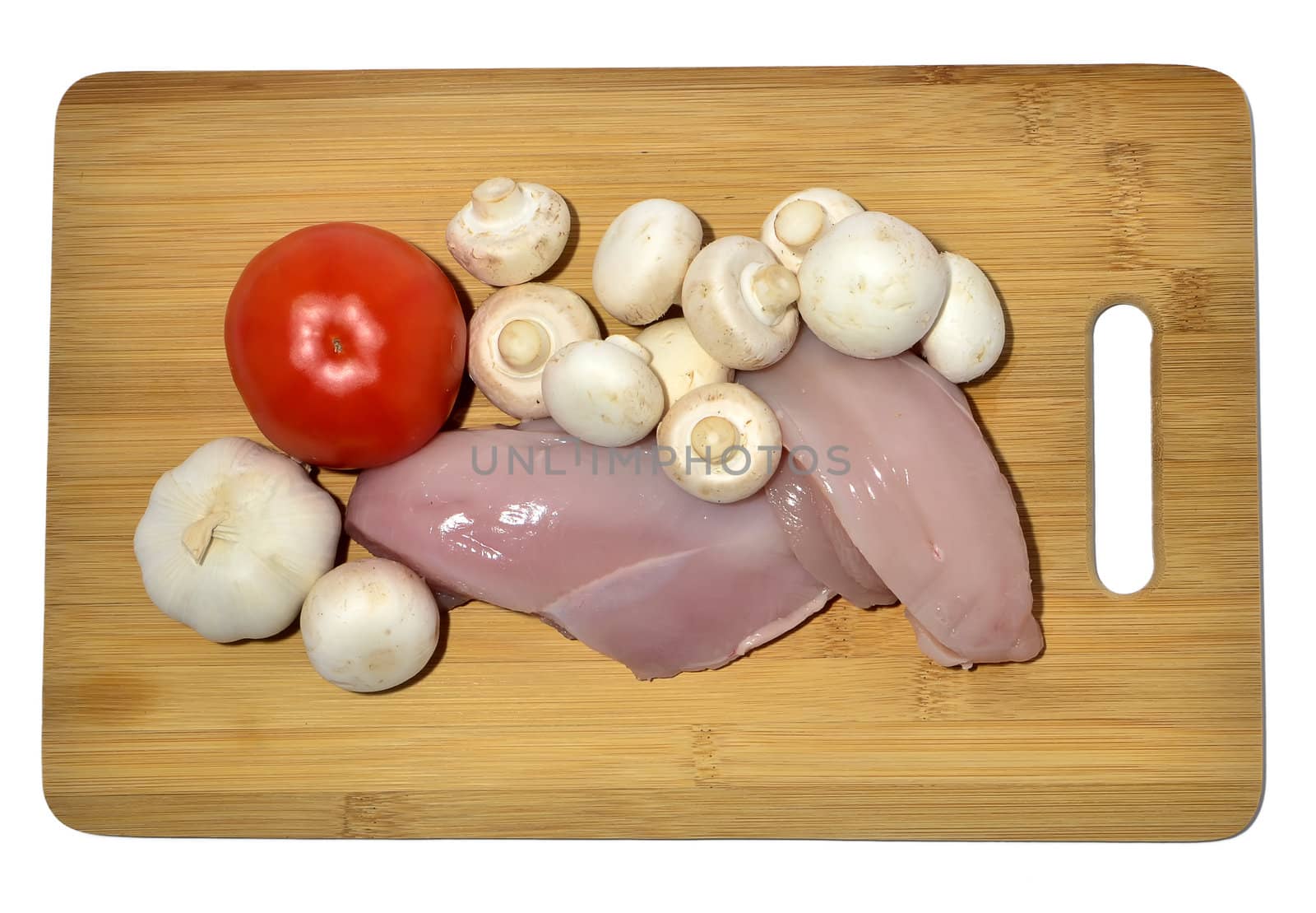 chicken and vegetables on a cutting board, isolated on white