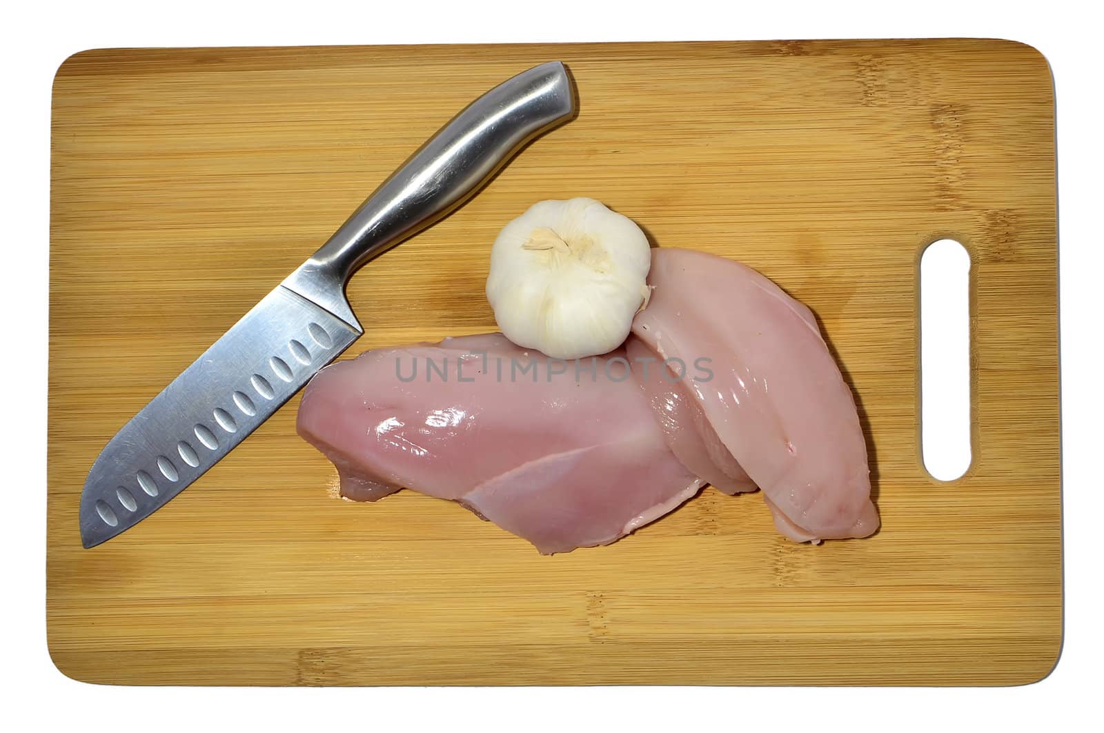 chicken, knife and garlic on a cutting board, isolated on white